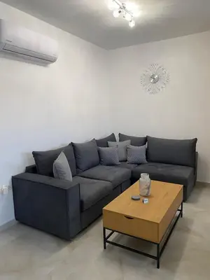 a living room with a couch and a coffee table at ELMA apartment 2 Kremasti in Kremasti