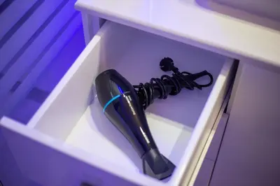 a black umbrella sticking out of a white drawer at ELMA apartment 2 Kremasti in Kremasti