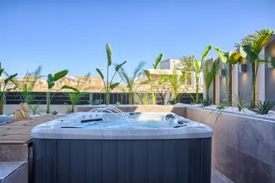 a jacuzzi tub in a backyard with trees at Casa De Sario in Rhodes Town