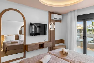 a bedroom with a mirror and a tv and a bed at Casa De Sario in Rhodes Town