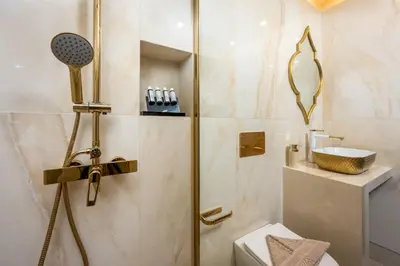 a bathroom with a shower with a toilet and a sink at Symi's Jewel in Symi