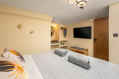a bedroom with a bed with two pillows on it at Symi's Jewel in Symi