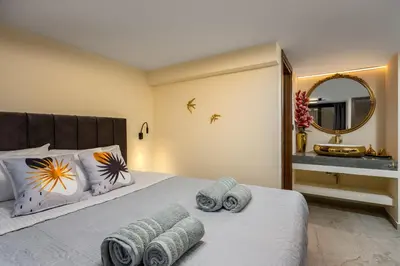 a bedroom with a bed with towels on it at Symi's Jewel in Symi