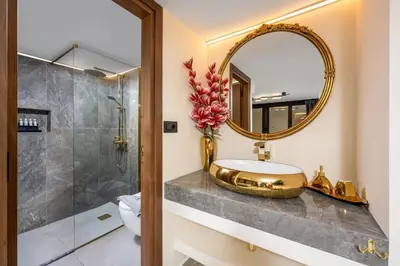 a bathroom with a sink and a mirror at Symi's Jewel in Symi