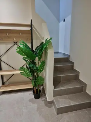 a plant in a pot next to a staircase at Bliss Sunrise Penthouse in Asgourou