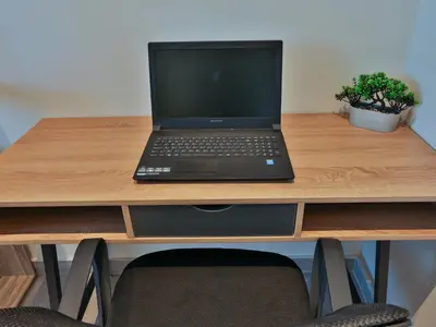 a laptop computer sitting on top of a wooden desk at Bliss Sunrise Penthouse in Asgourou