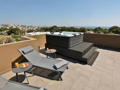 a hot tub on the roof of a house at Bliss Sunrise Penthouse in Asgourou