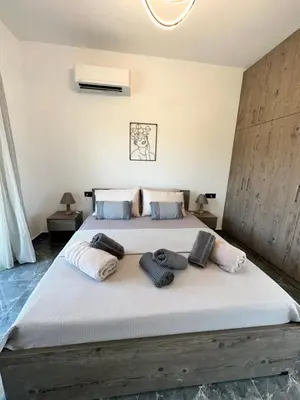 a bedroom with a large bed with towels on it at Villa Mike in Rhodes Town