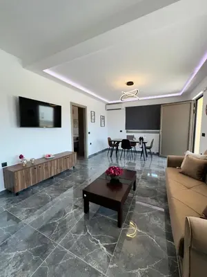 a living room with a couch and a table at Villa Mike in Rhodes Town