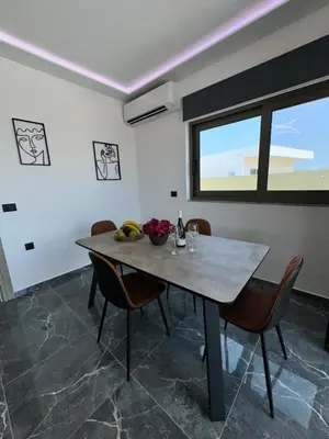 a dining room with a table and chairs at Villa Mike in Rhodes Town