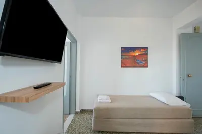 a living room with a flat screen tv on the wall at Mandilara Minimal Apartment in Rhodes Town