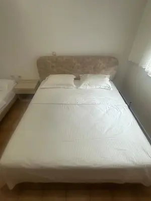 a large white bed in a small room at Κakle Kolympia Apartments in Kolimbia