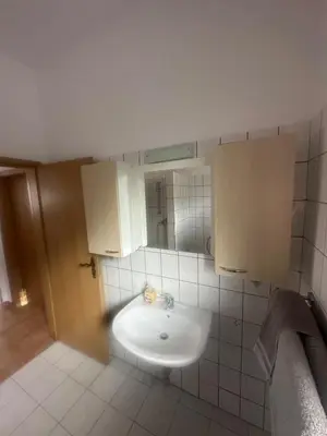 a bathroom with a sink and a mirror at Κakle Kolympia Apartments in Kolimbia