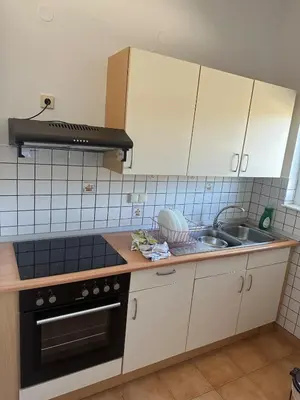 a kitchen with a sink and a stove at Κakle Kolympia Apartments in Kolimbia