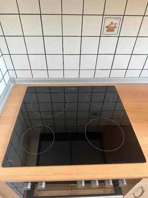 a view of a kitchen with a tile wall at Κakle Kolympia Apartments in Kolimbia
