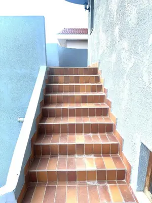 a set of stairs leading up to a building at Κakle Kolympia Apartments in Kolimbia