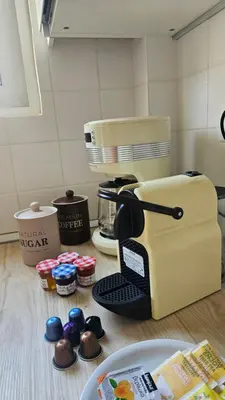 a kitchen counter with a coffee maker and cupcakes at OASIS Central 007 in Rhodes Town
