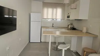 a kitchen with a counter and a white refrigerator at OASIS Central 007 in Rhodes Town