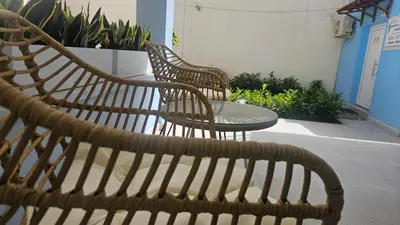 two wicker chairs and a table on a patio at OASIS Central 007 in Rhodes Town