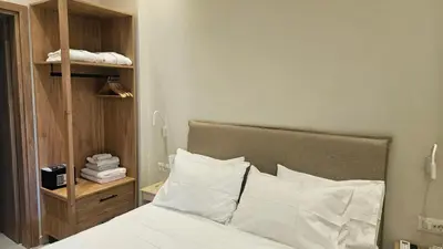 a bed with white sheets and pillows in a bedroom at OASIS Central 007 in Rhodes Town