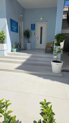 a building with potted plants in front of it at OASIS Central 007 in Rhodes Town