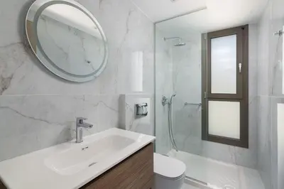 a white bathroom with a sink and a mirror at Rodos Stars Stellar Villas in Rhodes Town