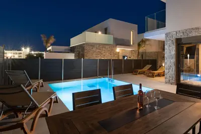 a house with a swimming pool at night at Rodos Stars Stellar Villas in Rhodes Town