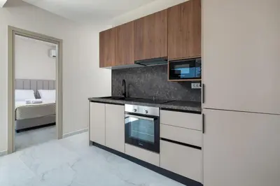 a kitchen with a stove and a refrigerator at Rodos Stars Stellar Villas in Rhodes Town
