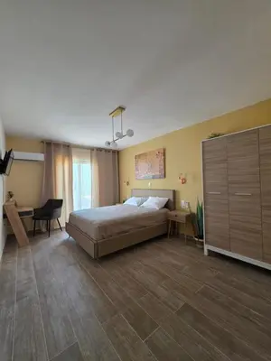 a bedroom with a bed and a desk and a cabinet at Canvas at Koskinou in Koskinou