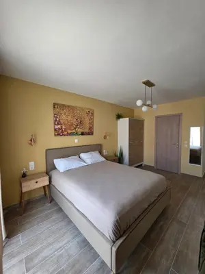 a bedroom with a bed and a painting on the wall at Canvas at Koskinou in Koskinou