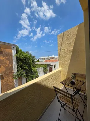 a balcony with a table and chairs on a building at Canvas at Koskinou in Koskinou