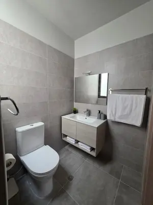 a bathroom with a toilet and a sink and a mirror at Canvas at Koskinou in Koskinou