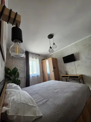 a bedroom with a large bed and two lights at Canvas at Koskinou 2 in Koskinou