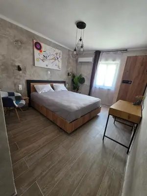 a bedroom with a large bed and a table at Canvas at Koskinou 2 in Koskinou