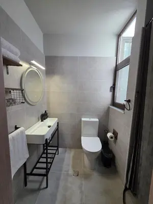 a bathroom with a toilet and a sink and a mirror at Canvas at Koskinou 2 in Koskinou