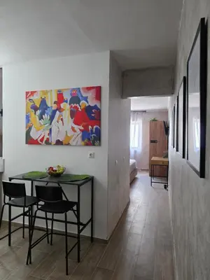 a dining room with a table and a painting on the wall at Canvas at Koskinou 2 in Koskinou