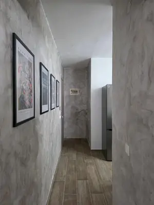 a hallway with concrete walls and a refrigerator at Canvas at Koskinou 2 in Koskinou