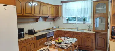 a kitchen with wooden cabinets and a table with fruits on it at Ioanna's Home in Émbonas