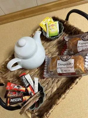 a wicker basket with a teapot and some snacks at Ioanna's Home in Émbonas