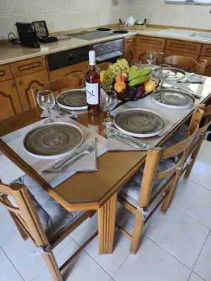 a wooden table with plates and fruit on it at Ioanna's Home in Émbonas