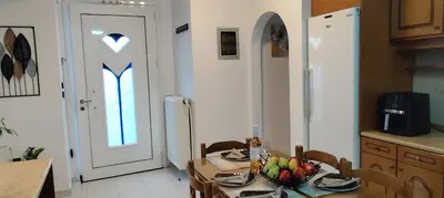 a kitchen with a table with a bowl of fruit on it at Ioanna's Home in Émbonas
