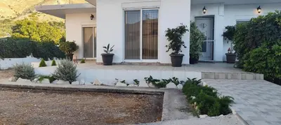 a house with birds sitting in the front yard at Ioanna's Home in Émbonas