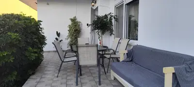 a patio with a couch and a table and chairs at Ioanna's Home in Émbonas