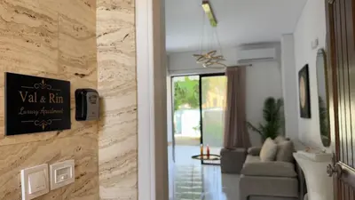 a hallway leading to a living room with a couch at Val & Rin Luxury Apartment in Rhodes Town