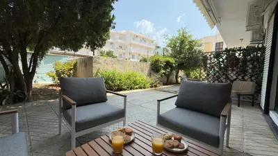 two chairs and a table on a patio with orange juice at Val & Rin Luxury Apartment in Rhodes Town