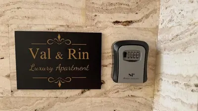 a phone on a wall with a sign on it at Val & Rin Luxury Apartment in Rhodes Town