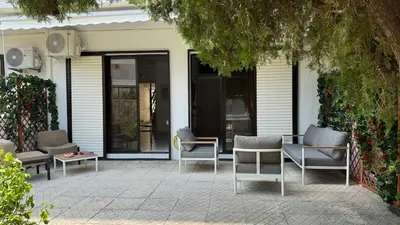 a patio with chairs and a table and a door at Val & Rin Luxury Apartment in Rhodes Town