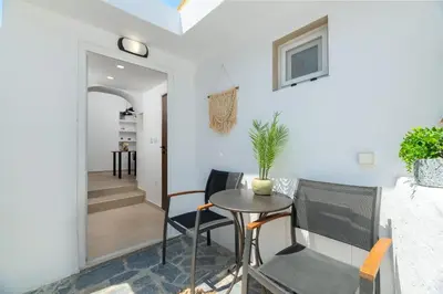 a dining room with a table and chairs and a hallway at Icarus Residence in Rhodes Town