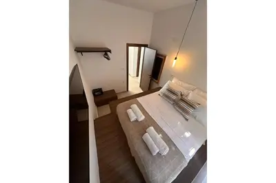 a bedroom with a bed with two towels on it at Icarus Residence in Rhodes Town
