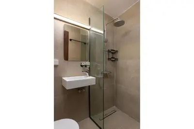 a bathroom with a sink and a glass shower at Icarus Residence in Rhodes Town